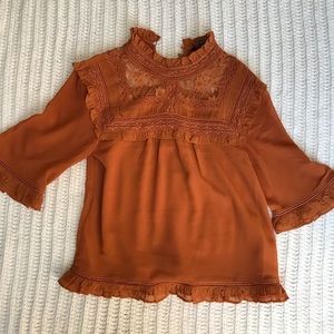 Burnt orange turtleneck blouse